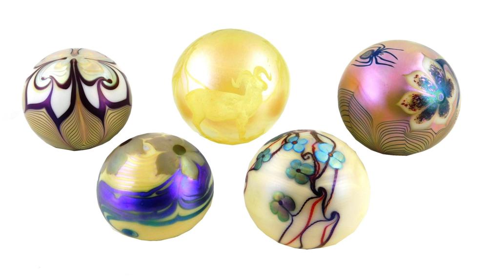 Appraisal: ART GLASS Five iridescent paperweights by Orient Flume American all