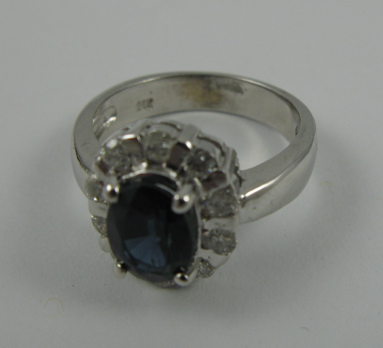 Appraisal: SAPPHIRE DIAMOND AND K WHITE GOLD RING centering an oval-cut