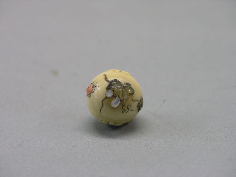 Appraisal: An ivory and shibayama ball Meiji period mounted with insects