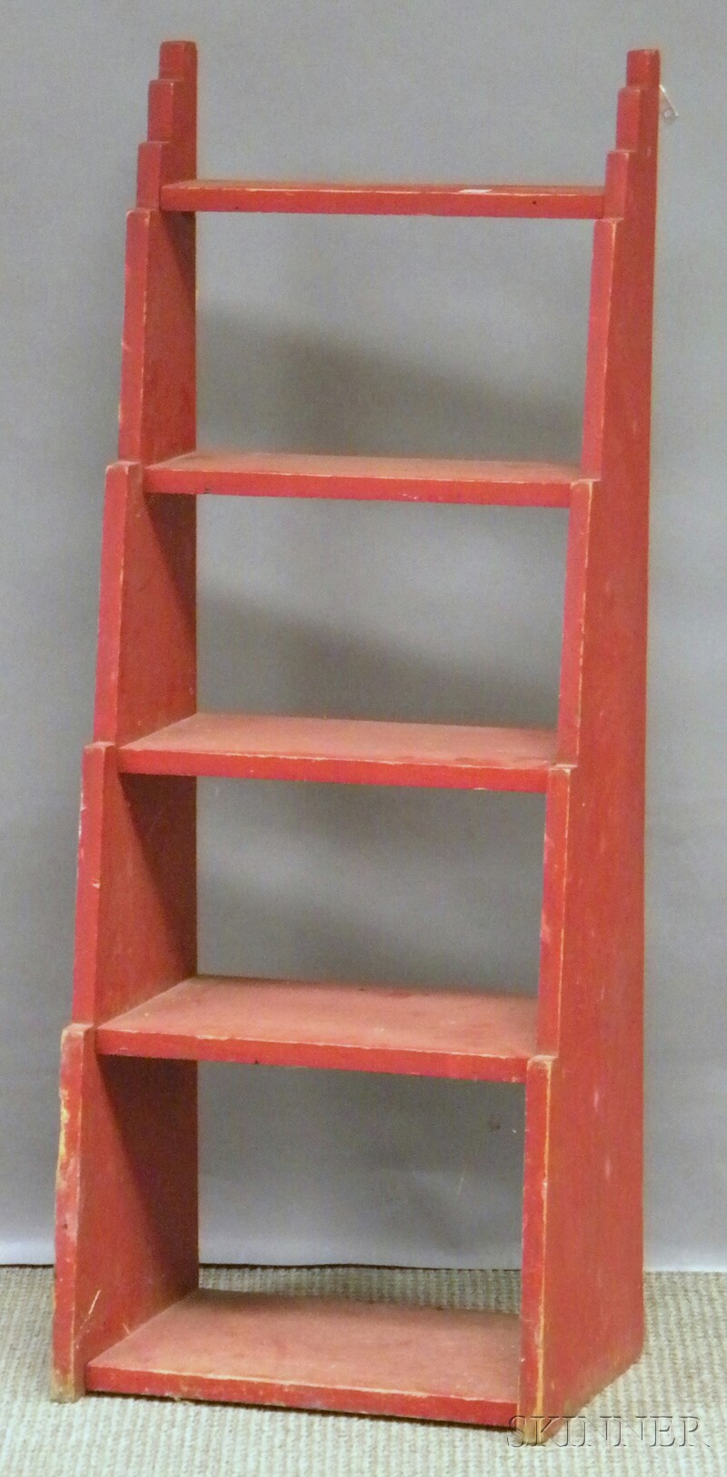 Appraisal: Red-painted Art Deco Wooden Step-sided Five-tier Wall Shelf lg wd