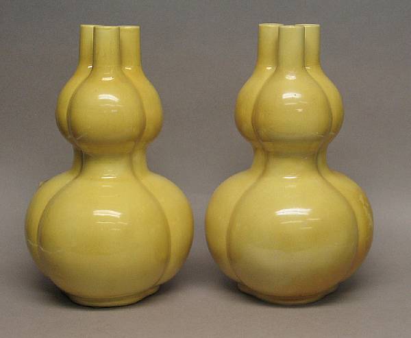 Appraisal: A pair of yellow glazed pottery triple gourd vases th