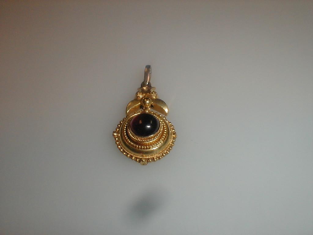 Appraisal: A Victorian circular pendant probably once an earring set centrally