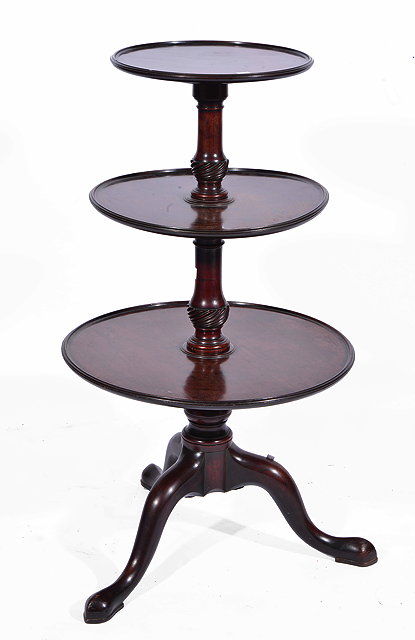 Appraisal: A GEORGIAN MAHOGANY THREE TIERED DUMB WAITER with turned support