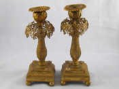 Appraisal: A pair of chased ormolo candlesticks the square bases on