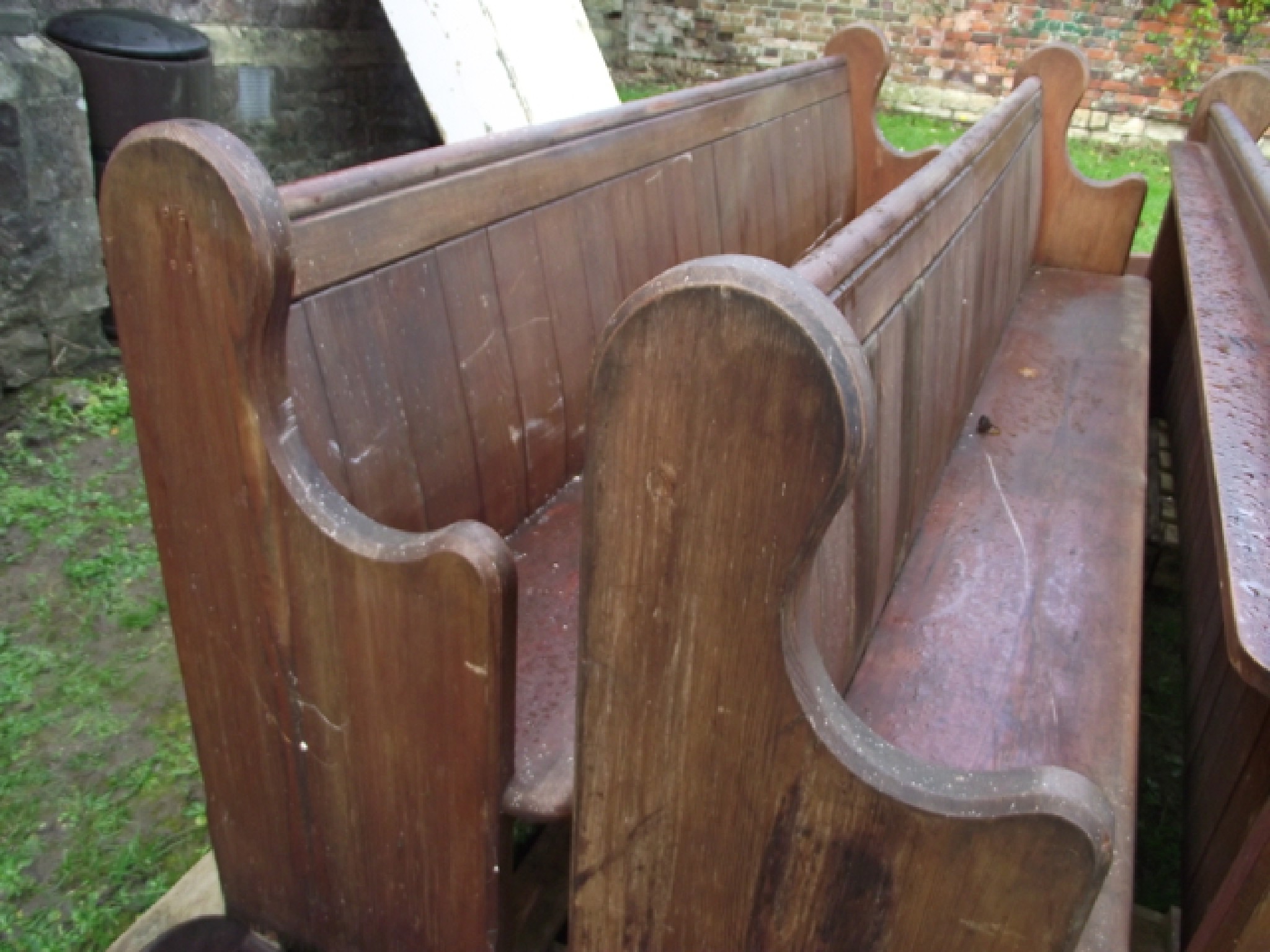 Appraisal: A pair of reclaimed pitch pine church pews with shaped