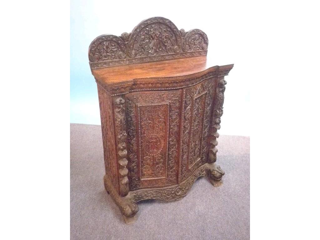 Appraisal: A thC Burmese hardwood chiffonier the raised back carved with