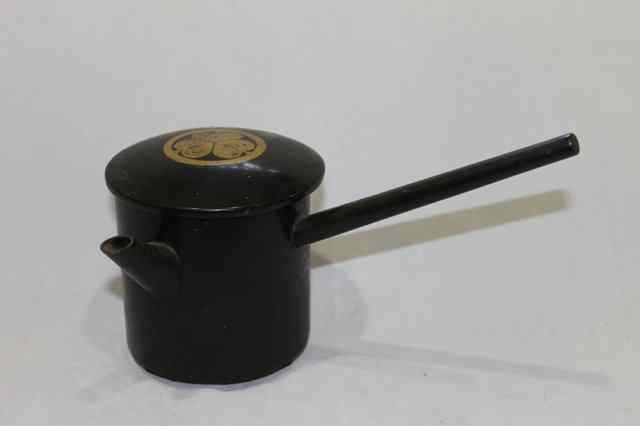 Appraisal: A JAPANESE LACQUER SIDE HANDLED WINE POT with gilt palm