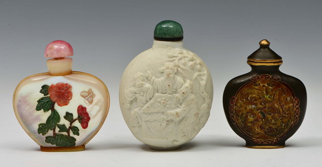 Appraisal: A CHINESE WHITE BISCUIT OVIFORM SNUFF BOTTLE moulded in relief