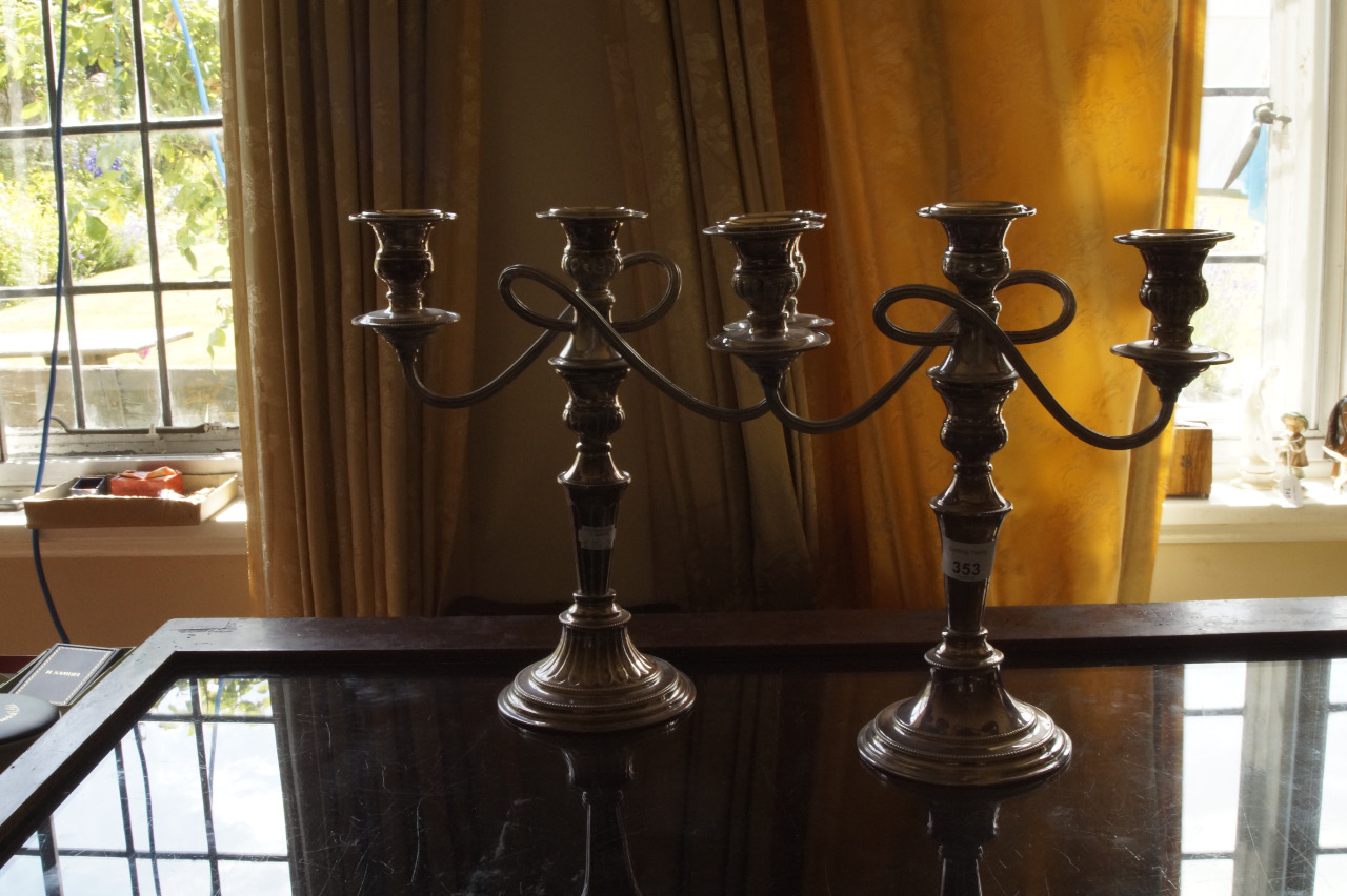 Appraisal: Two silver plated two branch candelabra with baluster stems and