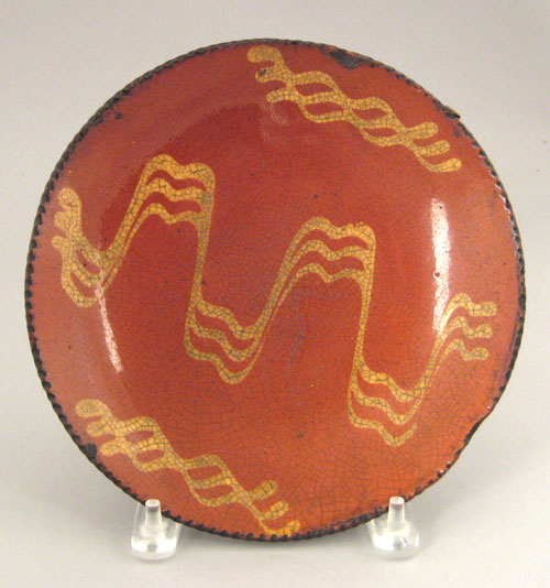 Appraisal: Redware pie plate th c with yellow slip decoration dia