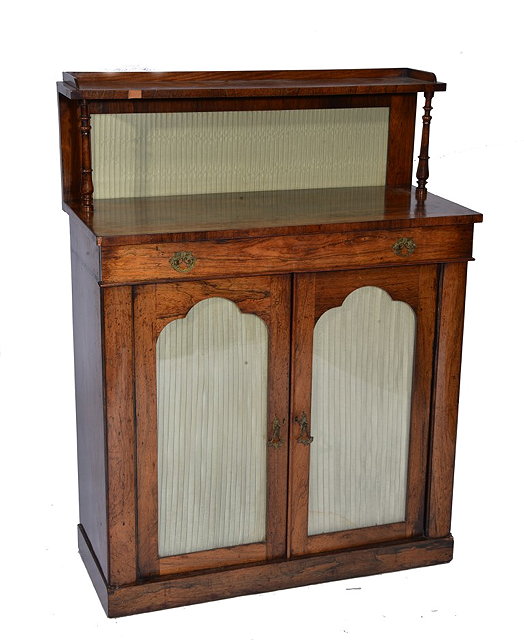 Appraisal: A LATE REGENCY ROSEWOOD CHIFFONIER with raised shelf back and