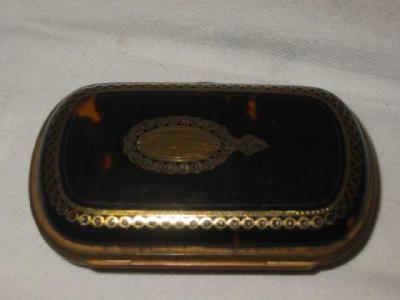 Appraisal: A TORTOISESHELL AND BRASS PURSE of rounded oblong hinged form