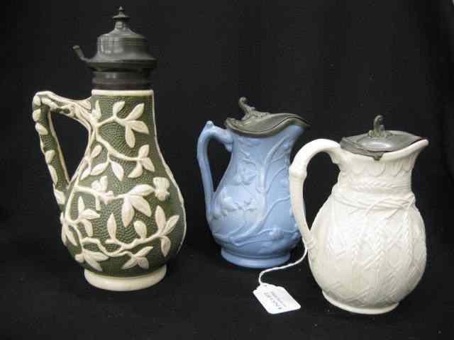 Appraisal: Victorian Syrup Pitchers English salt glaze raised designs circa tallest