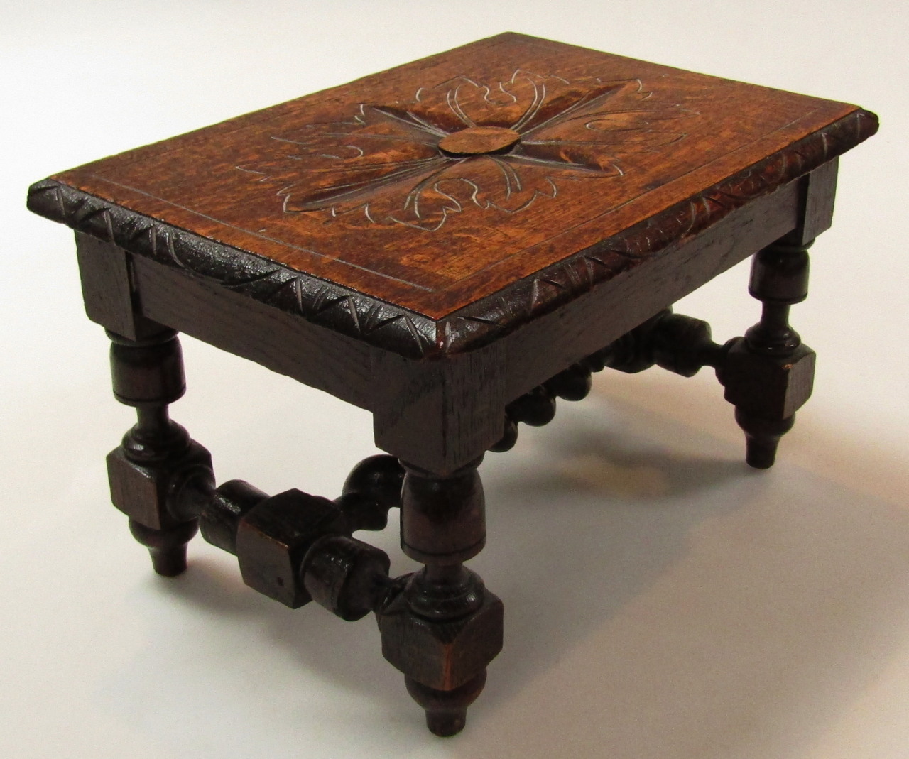 Appraisal: An early thC oak stool the rectangular outline with a