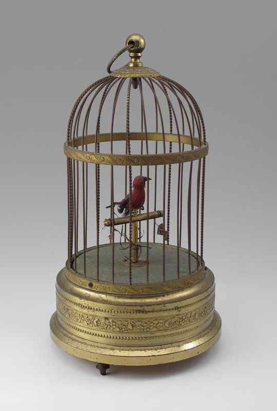 Appraisal: SINGING BIRD AUTOMATON Red feather bird head moves and chirps