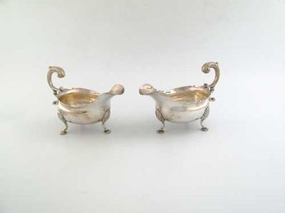 Appraisal: A pair of George II sauceboats on three cast shell