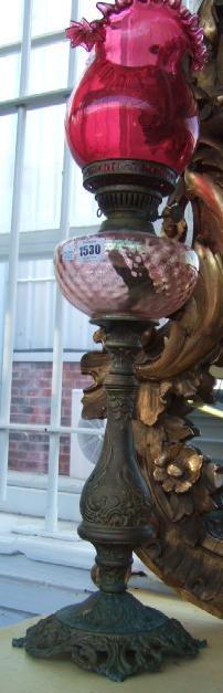 Appraisal: A Victorian gilt metal oil lamp with pink glass reservoir