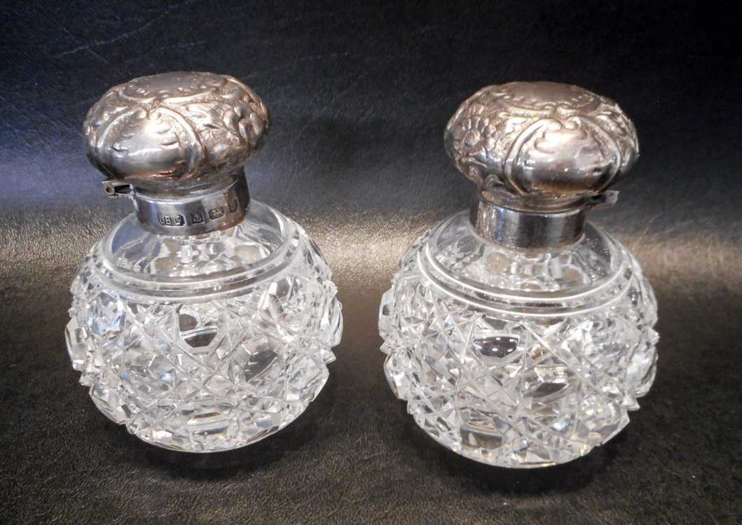 Appraisal: PAIR OF ENGLISH STERLING CUT GLASS SCENT BOTTLES with hinged