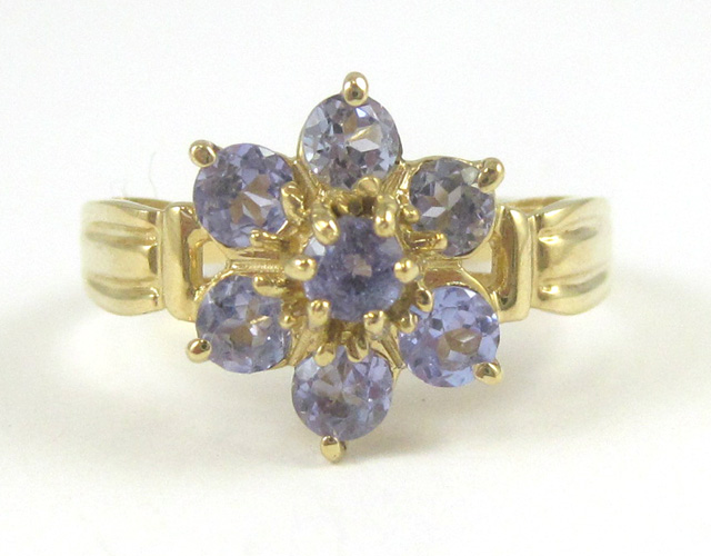 Appraisal: TANZANITE AND TEN KARAT GOLD RING set with seven round-cut