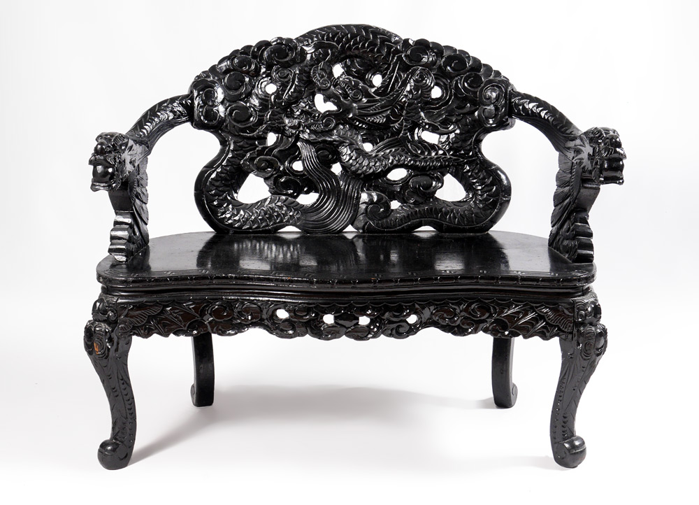 Appraisal: CARVED CHINESE EBONIZED DRAGON MOTIF SETTEE Ebonized finish dragon motif