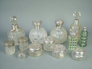 Appraisal: A collection of eleven glass and silver mounted scent bottles