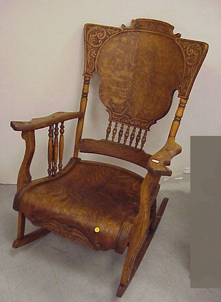 Appraisal: Oak rocking chair with pressed back Foliate carving on the