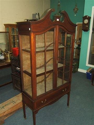 Appraisal: An Edwardian mahogany display cabinet with swan neck pediment satinwood