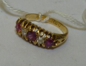 Appraisal: A RUBY AND DIAMOND FIVE STONE RING having three round