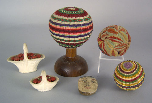 Appraisal: Yarn covered pincushion mounted on a wooden stand together with