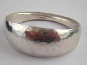 Appraisal: A heavy silver bangle with hammered finish approx cm at