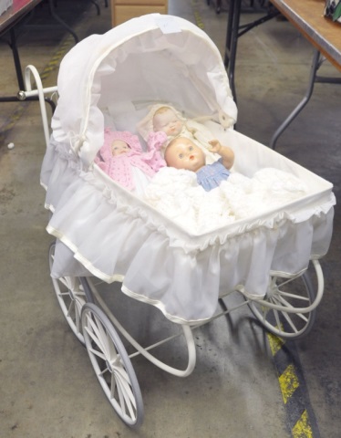 Appraisal: Large Doll BuggyAlong with three porcelain and composition dolls Buggy