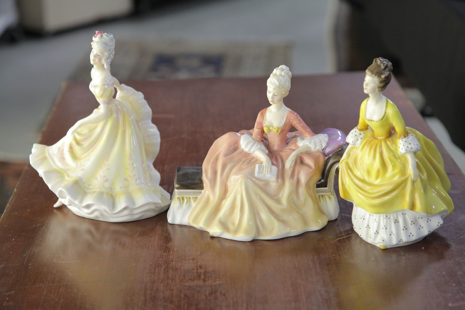 Appraisal: THREE ROYAL DOULTON FIGURES English th century Coralie HN ''h