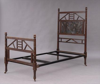 Appraisal: EGYPTIAN-STYLE OAK BEDSTEAD The headboard with latticework over embossed copper