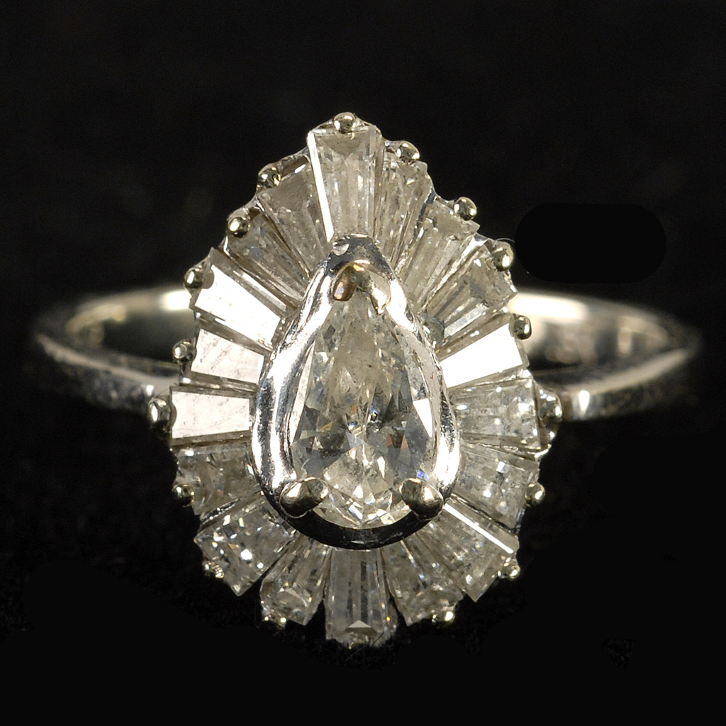 Appraisal: KT WHITE GOLD AND DIAMOND RING Central pear-cut stone surrounded