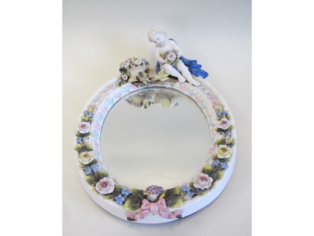 Appraisal: Continental oval porcelain framed mirror decorated with a cherub surrounded