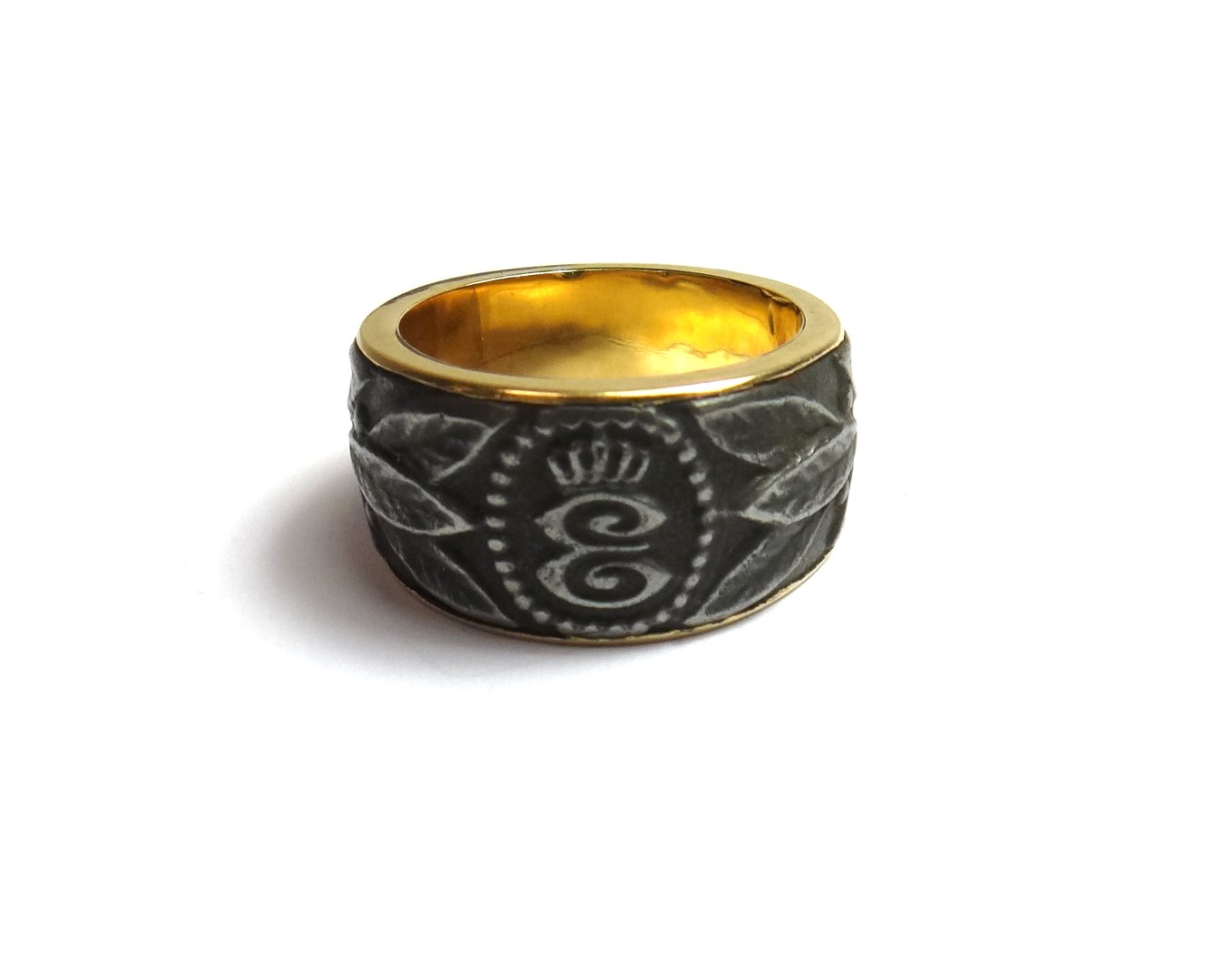 Appraisal: A gold and cast iron ring designed as the initial