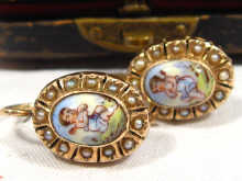 Appraisal: A pair of carat gold earrings with enamelled putti