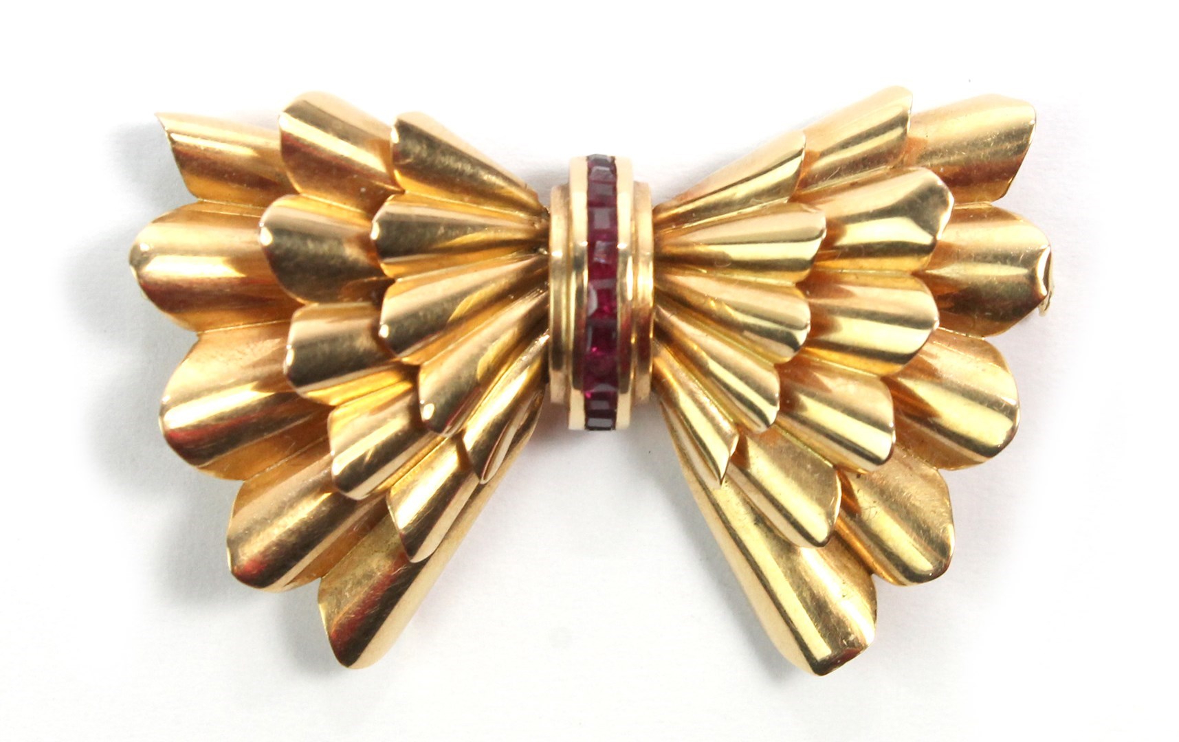 Appraisal: A gold and ruby set brooch designed as a stylized