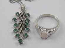 Appraisal: A white metal tests ct gold emerald pendant and a