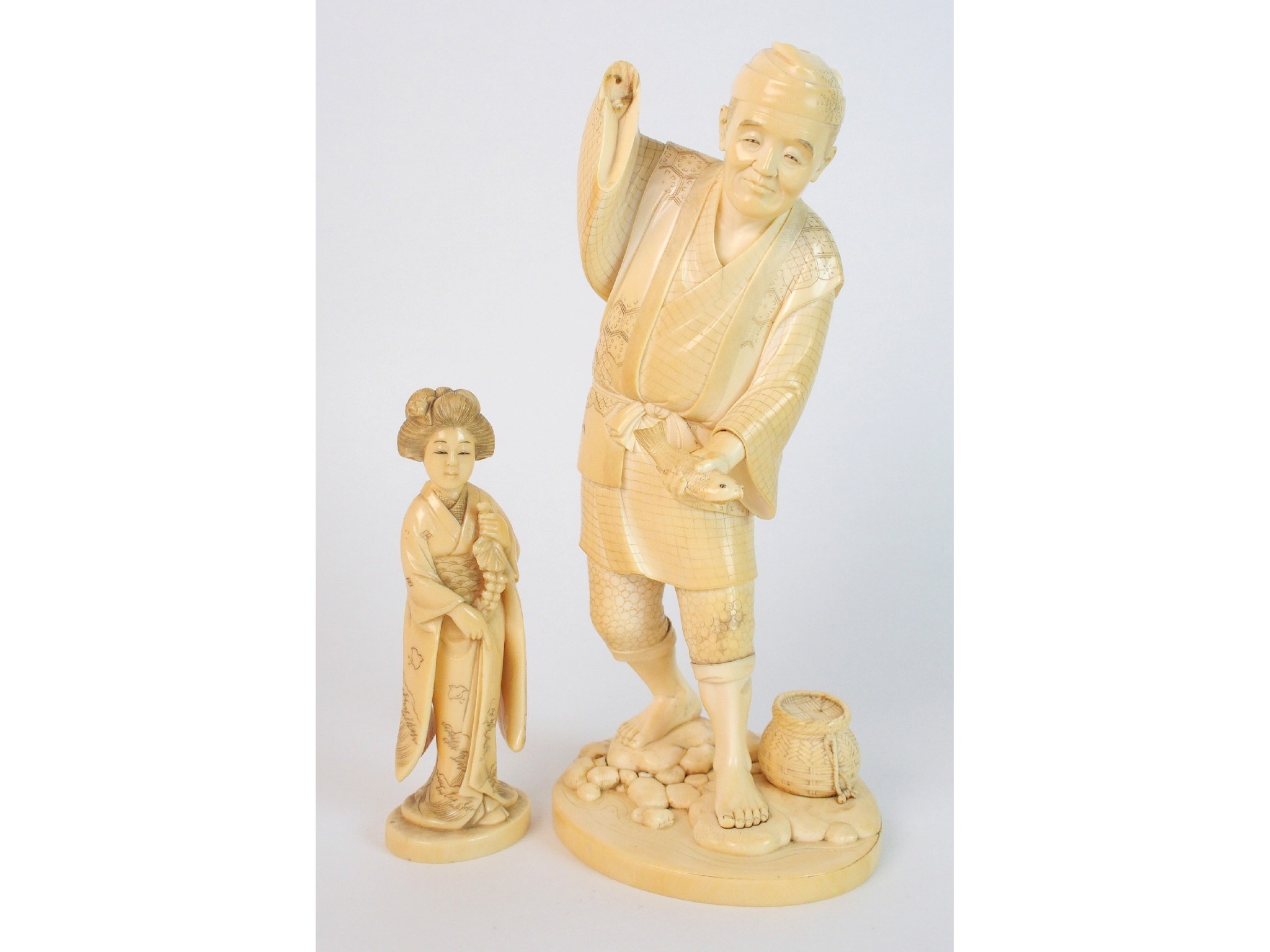 Appraisal: A Japanese ivory okimono of a fishermanstanding and holding a