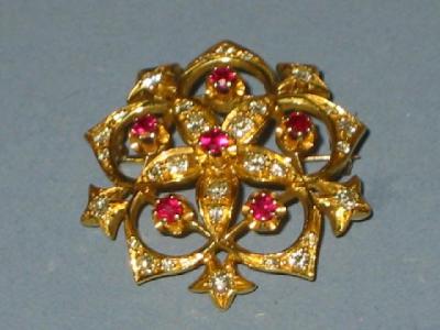 Appraisal: A RUBY AND DIAMOND BROOCH of circular form the yellow