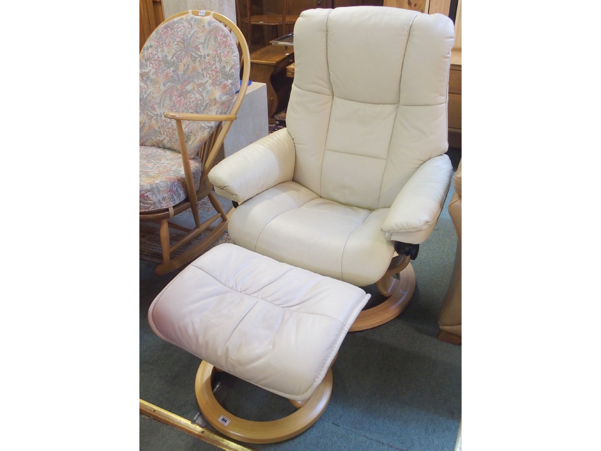 Appraisal: An Ekornes leather swivel recliner and footstool