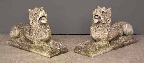 Appraisal: A pair of reconstituted stone cement models of recumbent lions