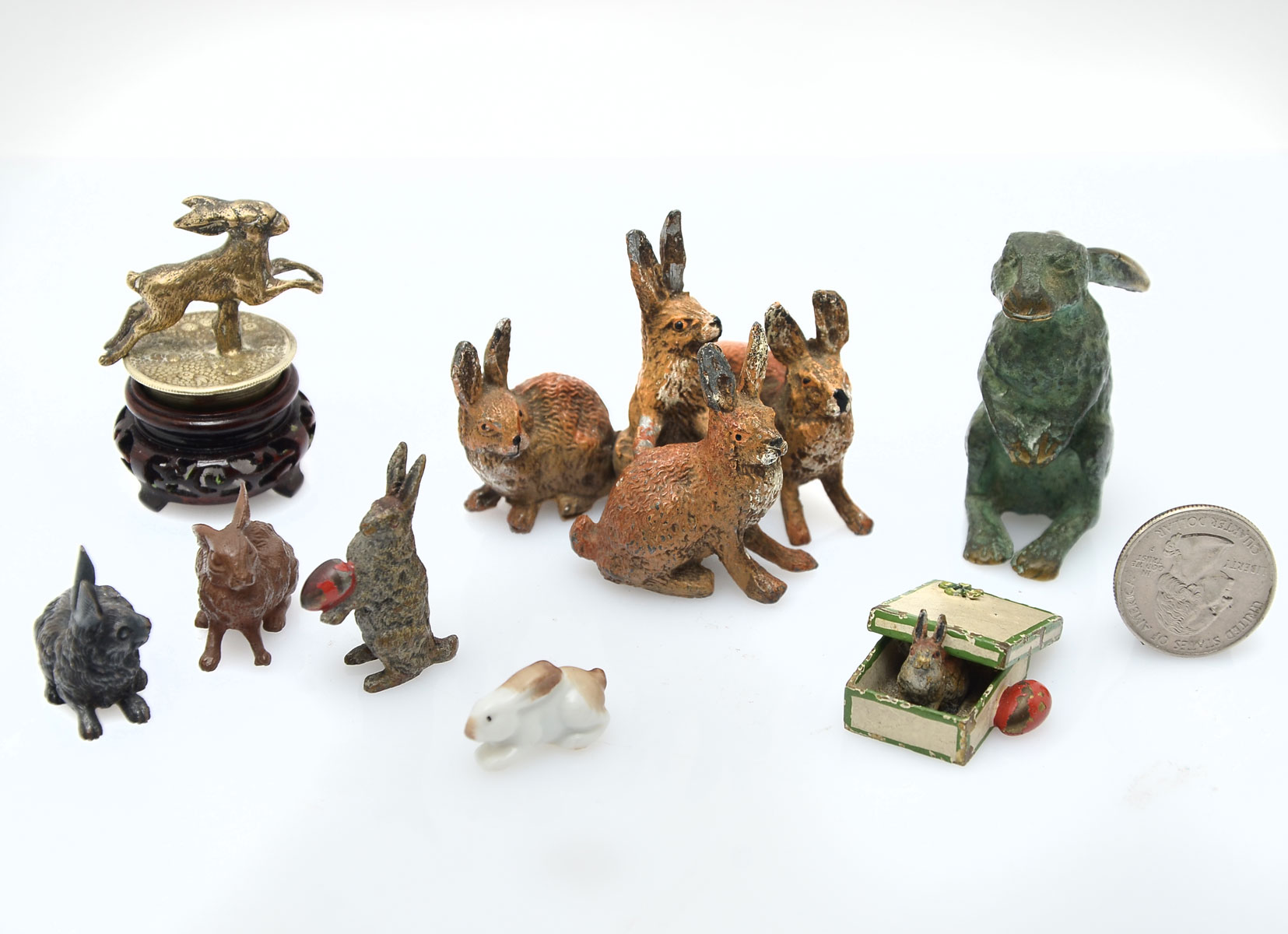 Appraisal: LOT OF MINIATURE RABBITS Comprising silvered copper cork topper painted