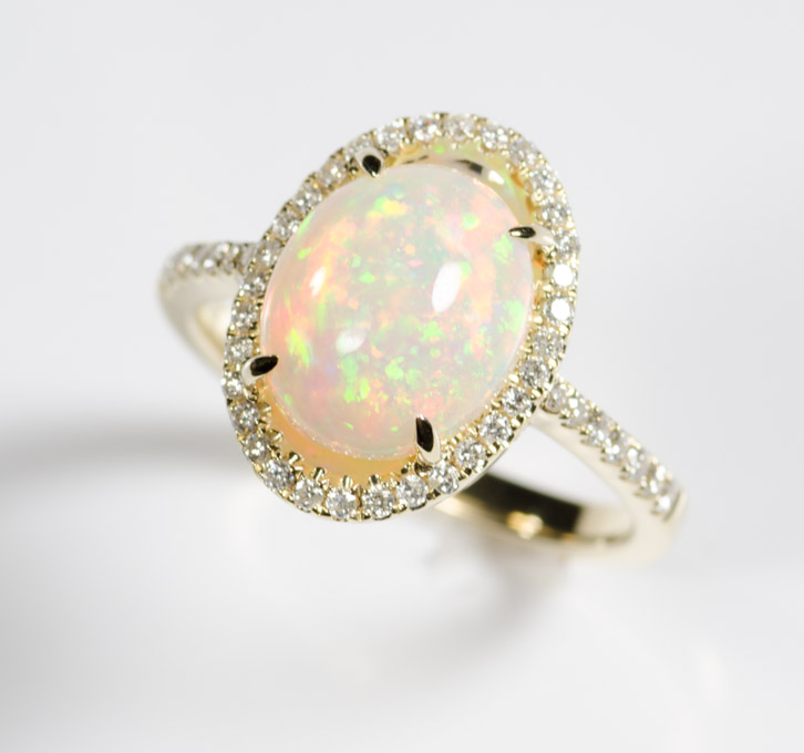 Appraisal: OPAL DIAMOND AND FOURTEEN KARAT GOLD RING with round-cut diamonds