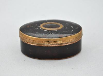 Appraisal: A Tortoise Snuff Box Of oval form with metal mounts