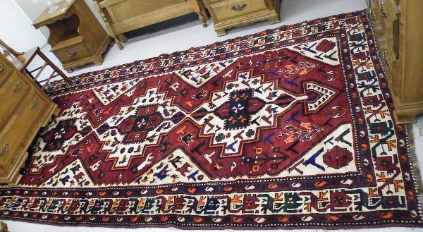 Appraisal: PERSIAN TRIBAL CARPET northwestern Iran three geometric medallion and stylized