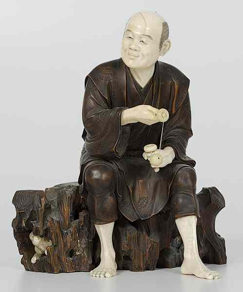 Appraisal: Japanese Ivory Okimono Figure Japan A carved wooden man with