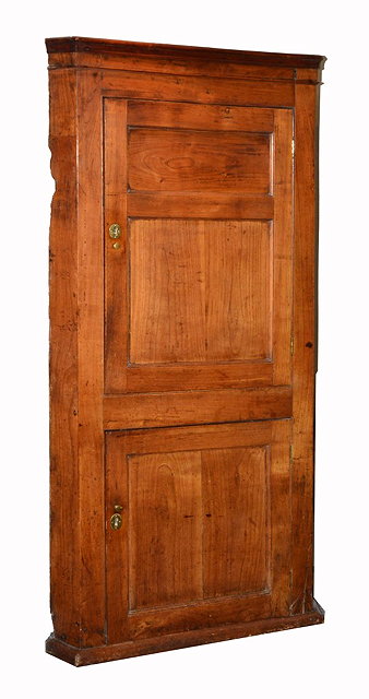 Appraisal: A GEORGE III FRUITWOOD FULL HEIGHT CORNER CUPBOARD with plain