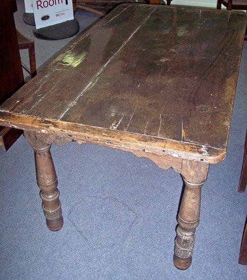 Appraisal: A rectangular fruitwood table with planked top on an oak